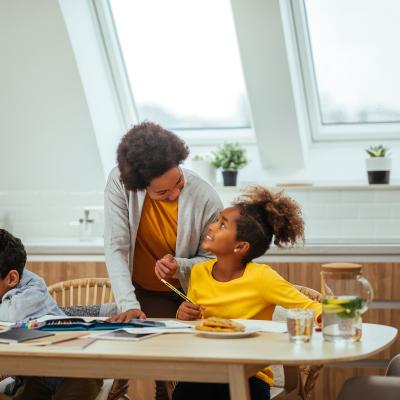 Mum dad son and daughter sit gather around table